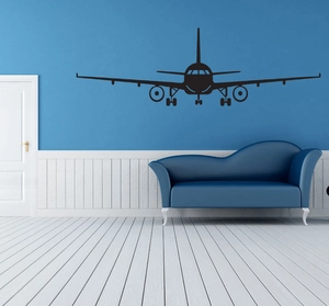 Macro detail of large black airplane silhouette wall sticker on a blue modern living room wall