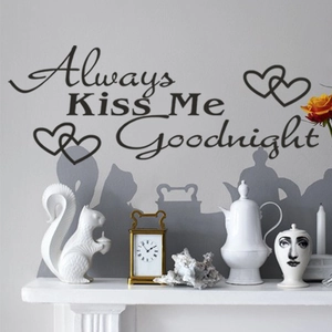 Detail of 'Always Kiss Me Goodnight' wall sticker with heart icons on bedroom wall