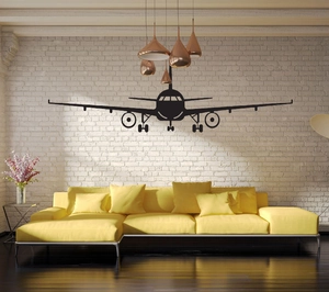 Detailed view of black airplane silhouette wall sticker on a modern living room brick wall