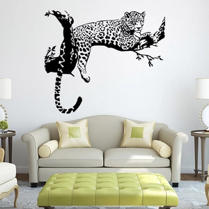 Macro detail of cheetah wall decal on a living room wall above a modern beige sofa