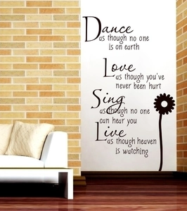 Detail of inspirational quote wall sticker with daisy flower in a modern living room