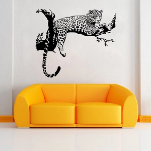 Detail view of a black leopard silhouette wall sticker above a yellow modern sofa