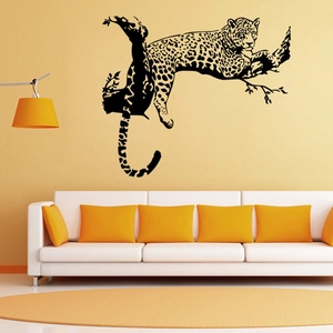 Detail of black leopard wall sticker on tree branch in modern minimalist living room decor