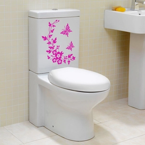 Pink butterfly and flower vine PVC wall sticker on a white ceramic toilet tank surface