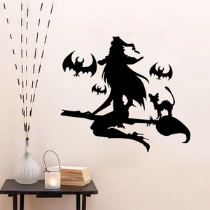 Macro detail of Halloween silhouette wall decals featuring witch, bats and cat on white wall