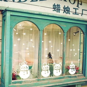 Festive white Christmas window stickers with four cute snowmen and delicate snowflakes