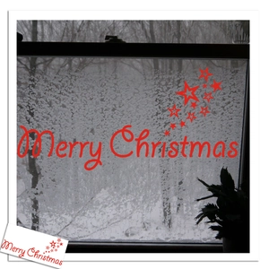 Red Merry Christmas wall sticker with stars on a frosted window for festive decoration