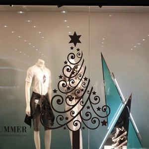 Detail of Christmas tree window sticker with silhouette pattern on a store front glass