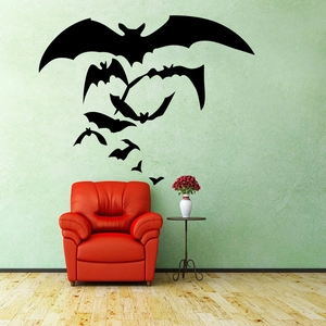 Black Halloween bat wall stickers set displayed on living room wall for holiday decoration