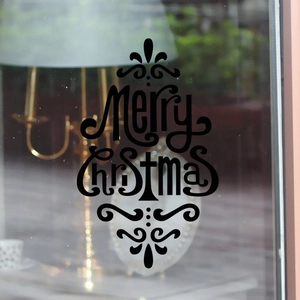 Detail of artistic black Merry Christmas glass sticker with elegant swirl patterns