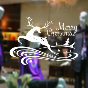 Sticker Noël blanc avec renne et étoiles sur une vitrine de magasin en verre