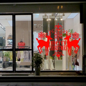 Red Christmas window sticker featuring reindeer and Merry Christmas text on glass
