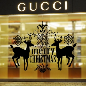 Close-up of black vinyl reindeer Christmas wall decal on store window glass surface