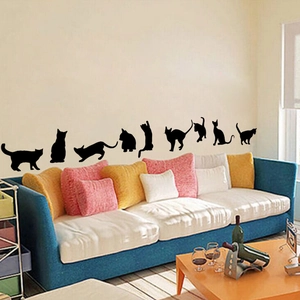 Detailed view of nine black playful cat silhouette wall stickers in various poses