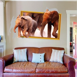 3D removable wall sticker featuring realistic elephants in a golden frame over a brown sofa