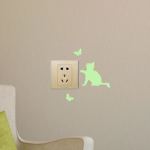 Luminous wall stickers featuring a cat and butterflies around a light switch socket