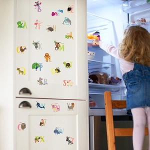 Set of 26 cartoon animal alphabet wall stickers for kids education on white cabinet