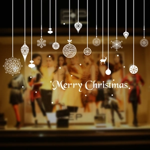 Detailed white Christmas window decals featuring snowflakes and reindeer on a glass surface