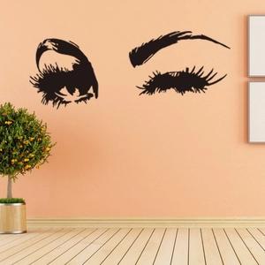 Sticker mural yeux et cils noirs minimalistes sur fond de mur orange et rose chaud