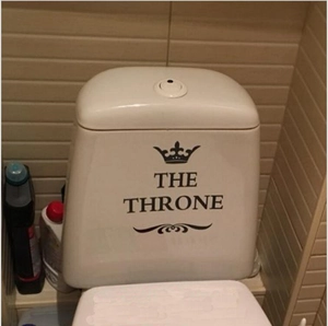 Detail of THE THRONE vinyl toilet sticker with crown design on bathroom tank surface