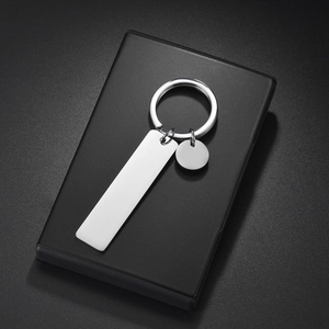 Macro shot of mirror-polished stainless steel blank rectangle and round tags for DIY engraving