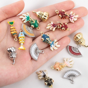 Assorted alloy koi fish, gourd, and fan pendants with enamel and sparkling rhinestones