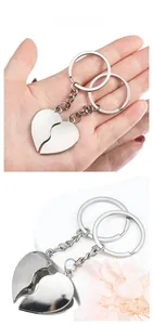 Close-up of interlocking heart-shaped metal keychains with polished silver finish