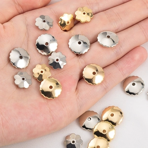 Gold and silver CCB plastic flower spacer beads held in hand for jewelry making DIY