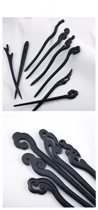 Detailed view of various black wooden hairpins with traditional Chinese cloud carvings