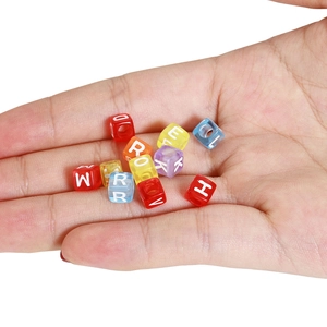 Handful of 6mm colorful transparent acrylic cube beads with white alphabet letters