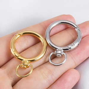 Zinc alloy swivel spring ring clasp in gold and silver finish shown on palm for scale