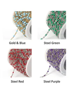 Detail of colorful enamel bead chains on spools in gold blue, steel green, red and purple