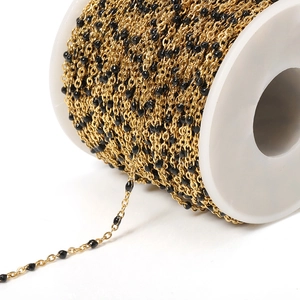 Gold-plated stainless steel ball chain with black enamel beads on a white spool