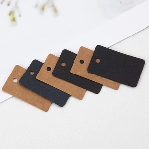 Brown and black kraft paper gift hang tags with pre-punched holes in minimalist layout