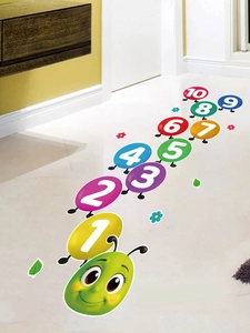 Detail view of colorful numbered caterpillar floor stickers on polished indoor tiles