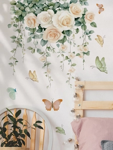 Detail of watercolor white rose wall stickers with colorful butterflies in bedroom setting