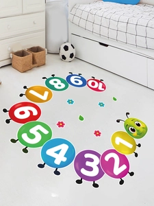 Detail of colorful caterpillar number floor stickers on white tile in a bright nursery