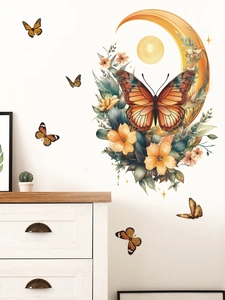 Detailed view of moon and butterfly wall stickers on white wall with cabinet