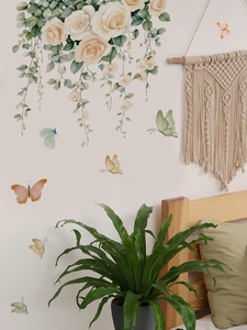 Close-up of watercolor champagne roses and butterflies wall stickers in a bedroom