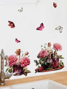 Detail of red rose and glass bottle wall stickers applied on white kitchen backsplash