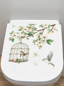 Floral branches and bird cage PVC self-adhesive wall stickers applied to a toilet cover