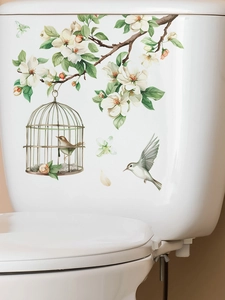 Detail of floral wall sticker with white blossoms and birds on white ceramic surface