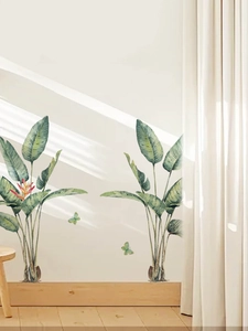 Detail of tropical plant wall decals with realistic green leaves and butterflies