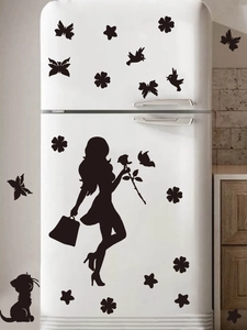 Close-up of elegant black PVC silhouette wall stickers on a white refrigerator surface