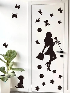 Detail view of black girl and rose silhouette wall stickers on a white door interior