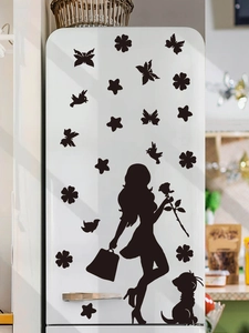 Detail of elegant black PVC stickers featuring female silhouette and roses on a white fridge
