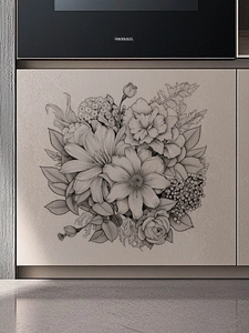 Détail de stickers muraux floraux noir et blanc sur la surface grise d'un meuble de cuisine