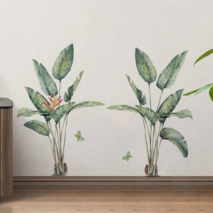 Tropical banana leaf wall decals with butterflies for a minimalist living room interior