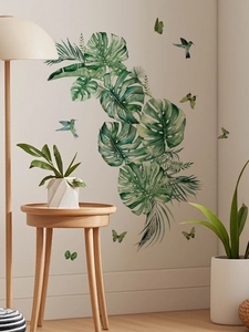 Detail of Monstera leaves and hummingbird wall decals in a Nordic living room decor