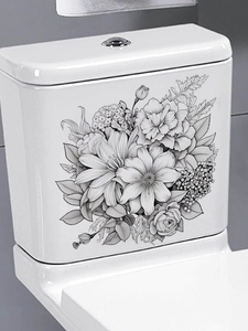 Détail d'un autocollant PVC avec croquis floral noir et blanc posé sur un réservoir WC